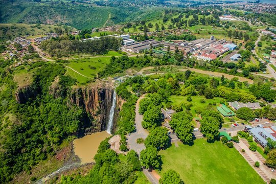 designer pool covers A scenic aerial view showcases a breathtaking waterfall nestled amidst lush green surroundings.
