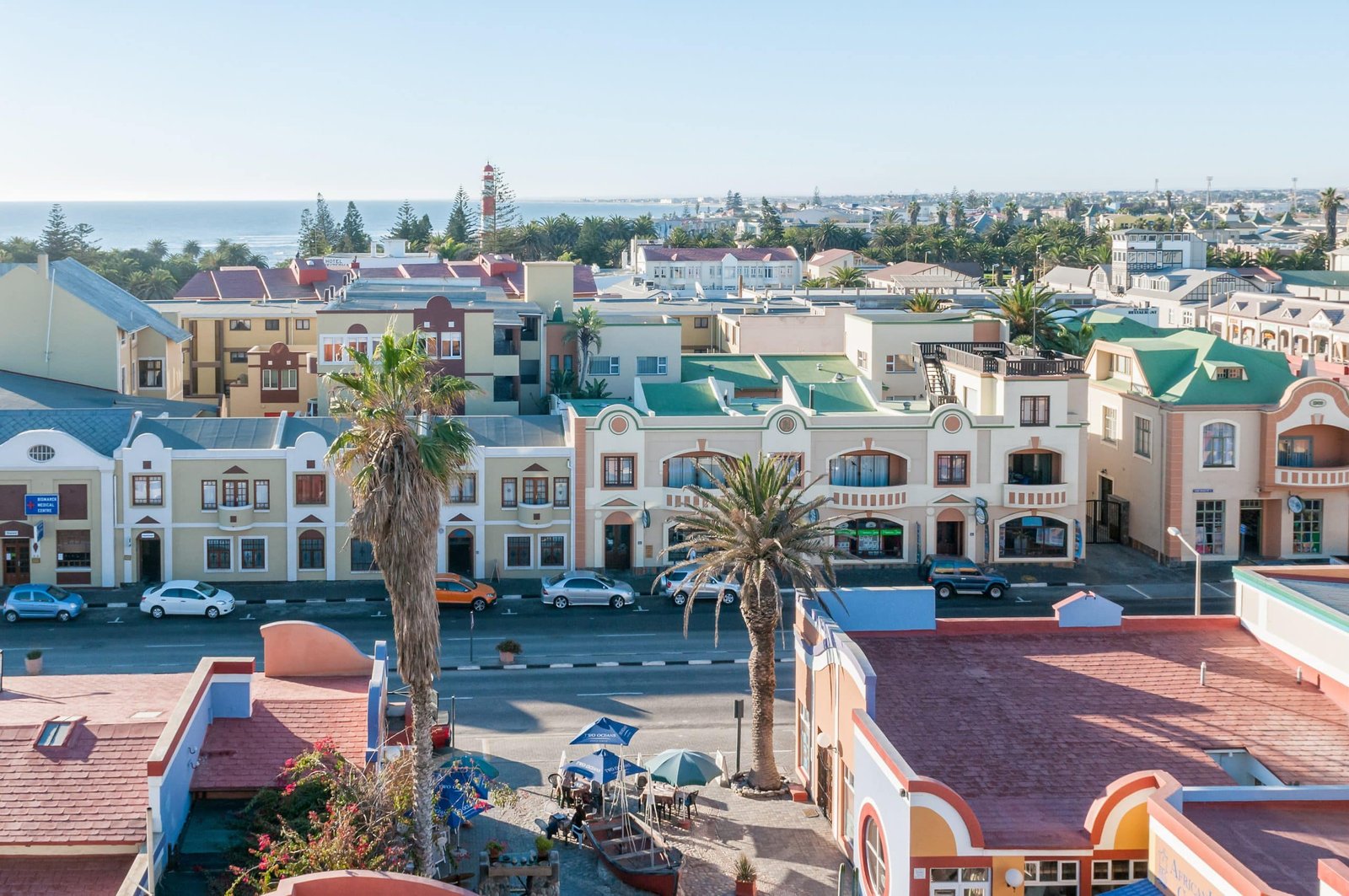 designer pool covers An aerial view of a city with colorful buildings and palm trees is complemented by the presence of beautiful pool covers.