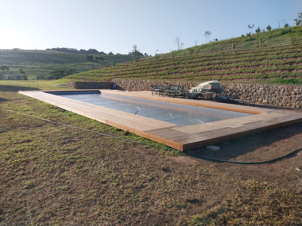 designer pool covers A wooden pool with a wooden deck.