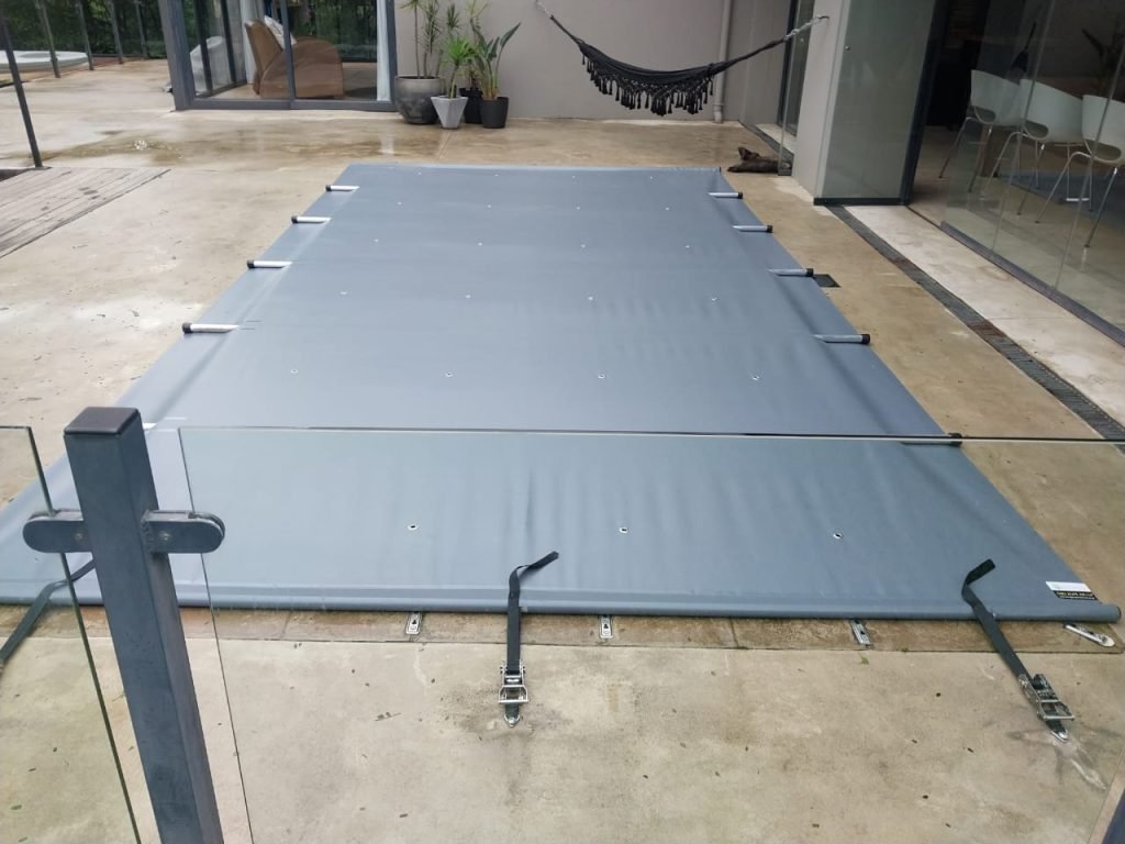 designer pool covers A swimming pool with a blue cover on it.